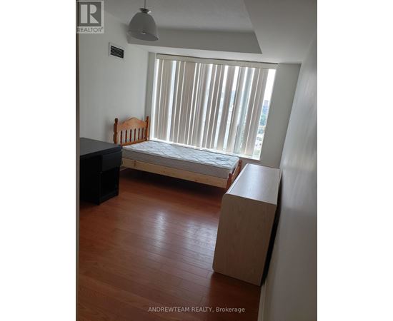 A bedroom with a bed, dresser and window with blinds.