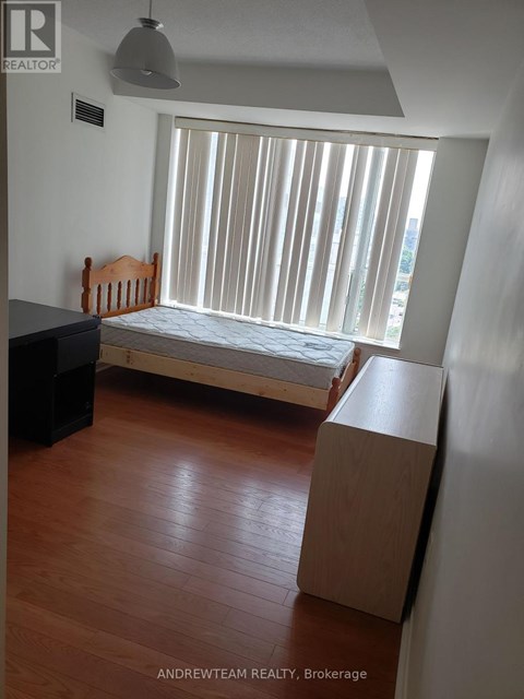 A bedroom with a bed, dresser and window with blinds.