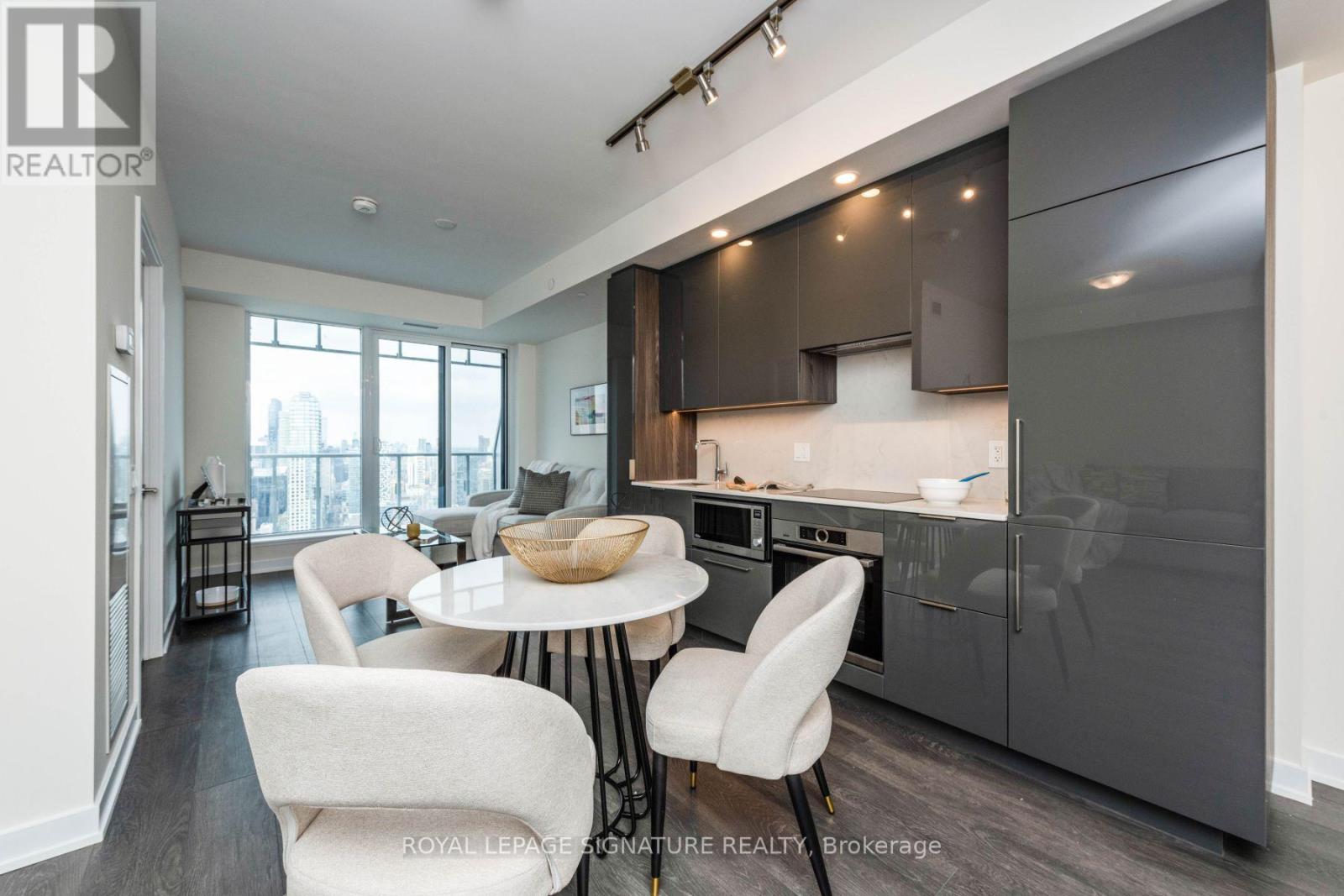 A modern kitchen with a dining table and chairs.