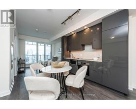 A modern kitchen with a dining table and chairs.