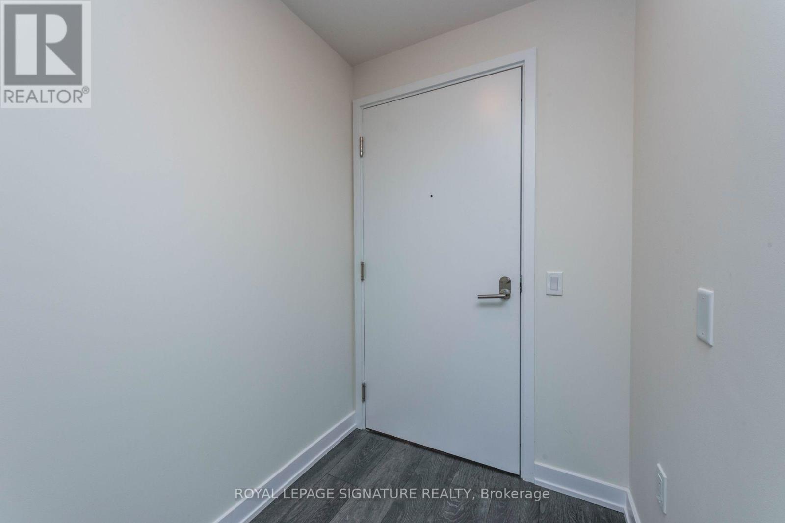 A white door in a room with a white wall.