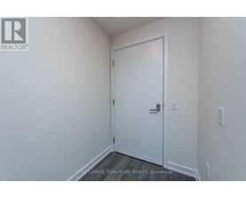 A white door in a room with a white wall.