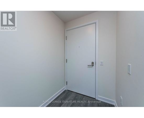 A white door in a room with a white wall.