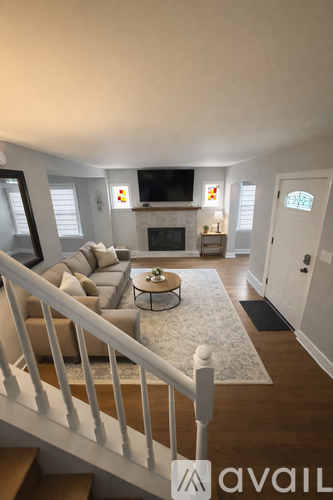 A living room with a couch, a coffee table, and a television.