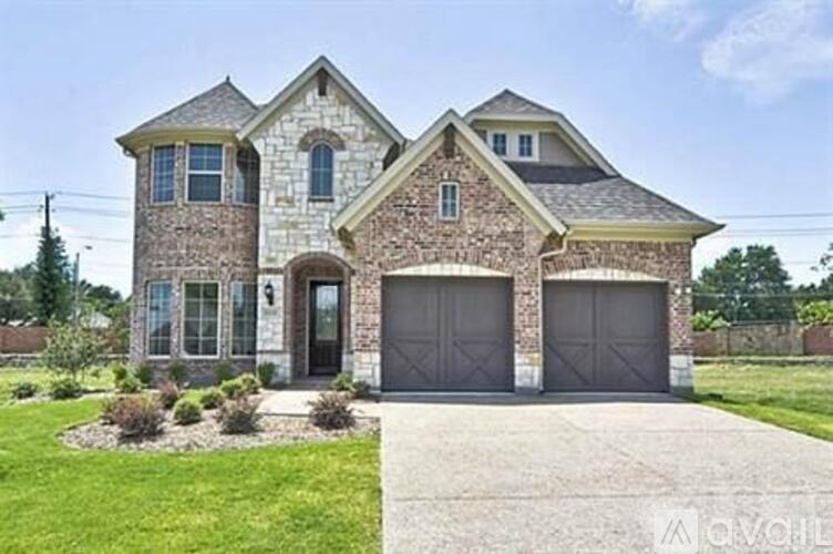 A two-story house with a garage and a driveway.