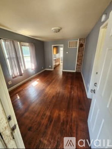 A room with wooden floors and a white door.