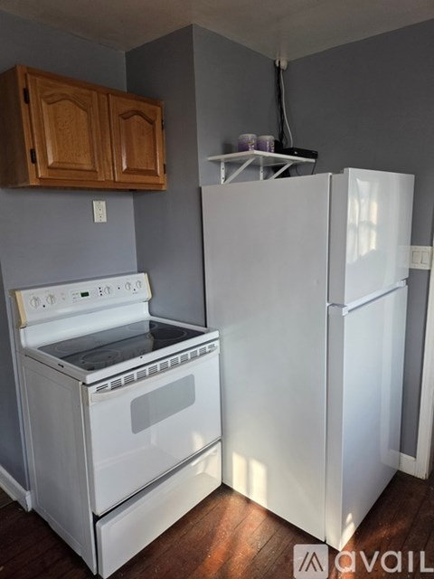 A white oven and refrigerator in a kitchen.