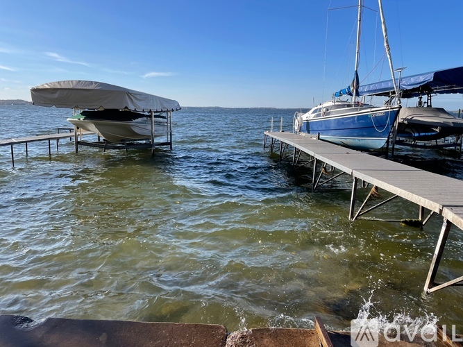 A boat is docked at a pier with a canopy over it.