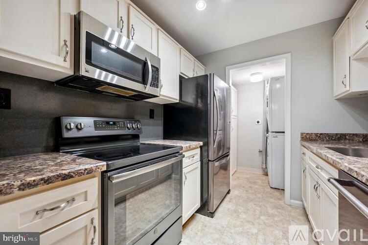 A kitchen with white cabinets and stainless steel appliances.