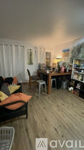 A living room with a couch, chair, and a bookshelf.