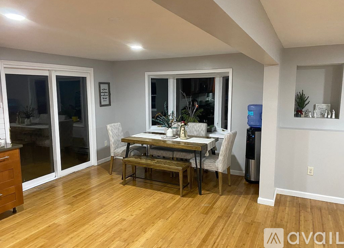A dining room with a wooden table and chairs.