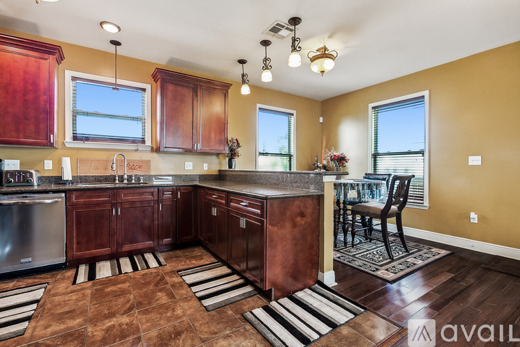 A kitchen with wooden cabinets and a large island.