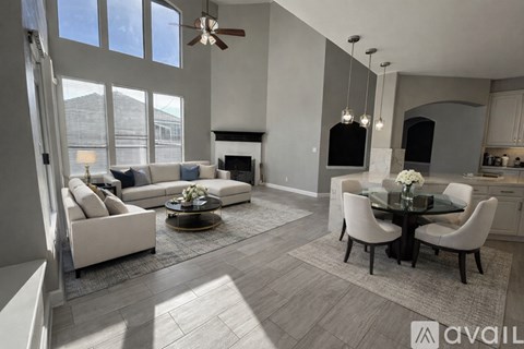 A bedroom with a large bed and a ceiling fan.