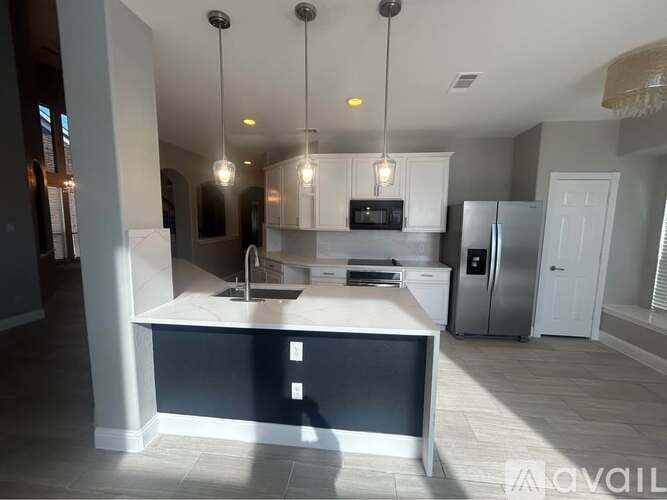 A modern kitchen with a large island in the middle.