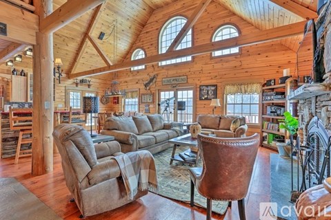 A living room with a large couch and a chair.