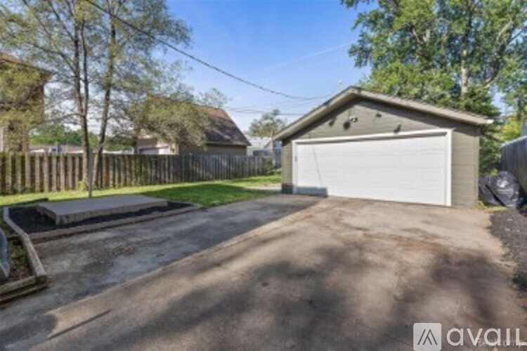 A residential area with a house, a garage, and a driveway.