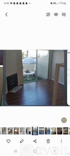 A room with a blackboard and a wooden floor.