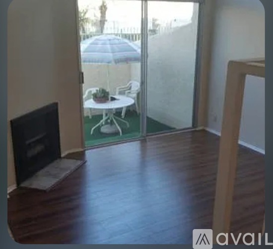 A living room with a fireplace and sliding glass doors leading to a patio.
