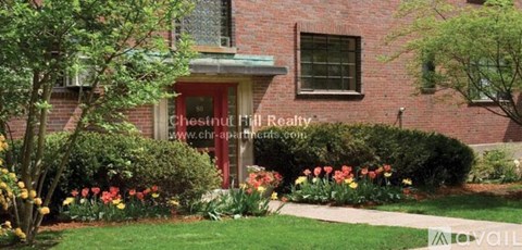 A red brick house with a sign that says Chestnut Hill Realty.