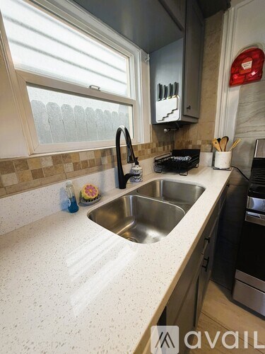 A kitchen with a sink and a window.