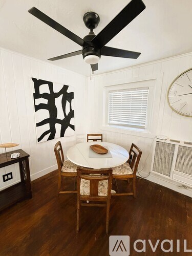 A dining room with a table set for four.