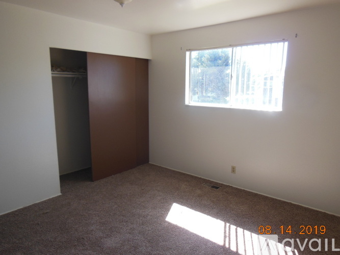 A room with a window and a door is available for rent.
