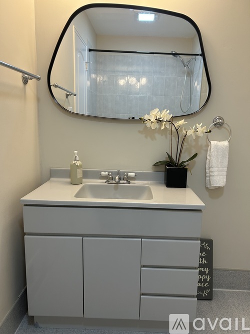 A bathroom with a sink and a mirror.