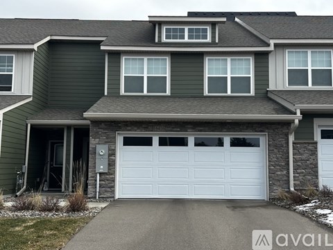 A house with a garage door that is currently open.