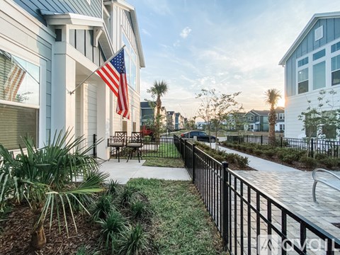 A row of houses with a flag hanging from the first house.