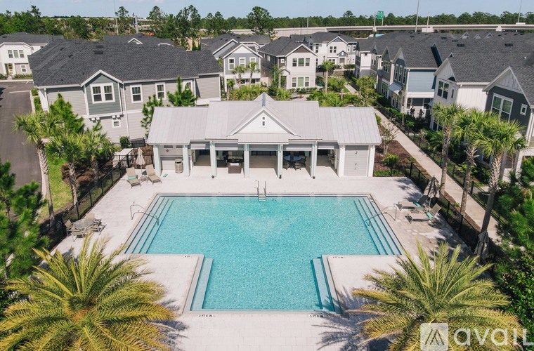 A large house with a pool in the middle of a backyard.
