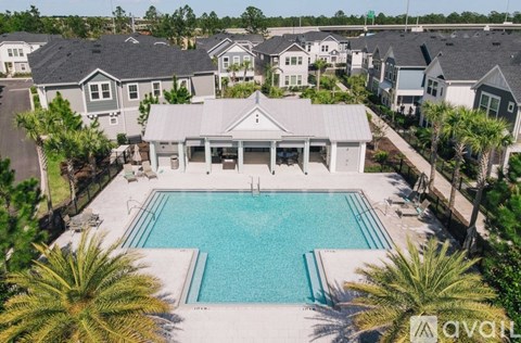 A large house with a pool in the middle of a backyard.