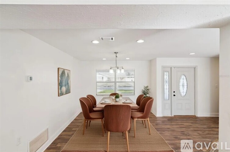 A dining room with a table set for six.