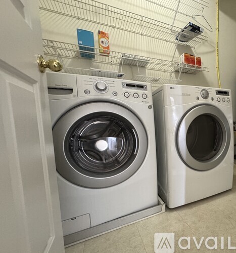 Two front loading washing machines in a laundry room.