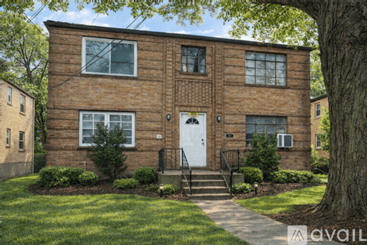 A brick house with a white door and windows.