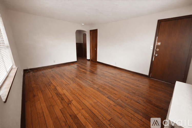 A room with wooden floors and white walls.