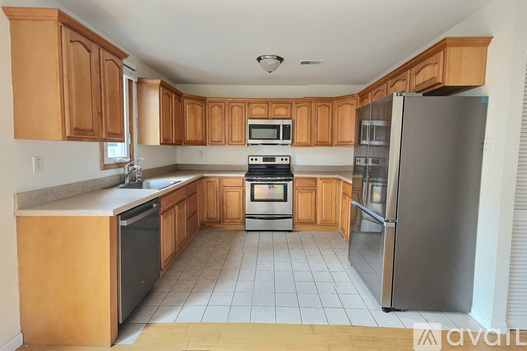 A kitchen with wooden cabinets and stainless steel appliances.