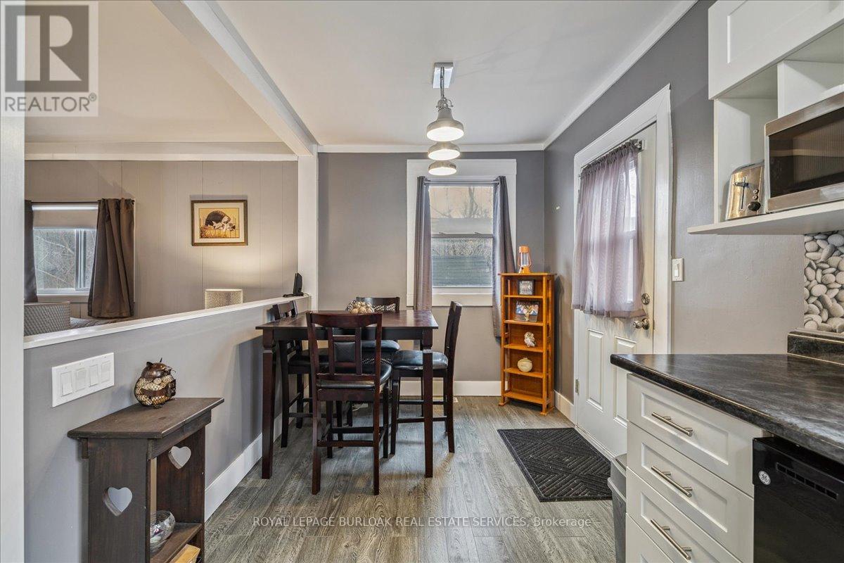 A dining room with a wooden table and chairs.