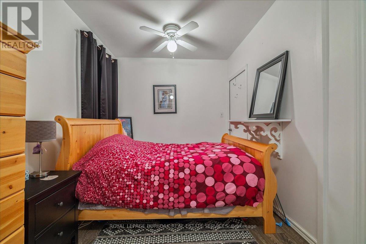A bedroom with a bed covered in a red and white polka dot comforter.