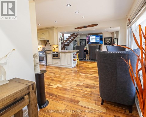 A living room with a grey couch and wooden floors.