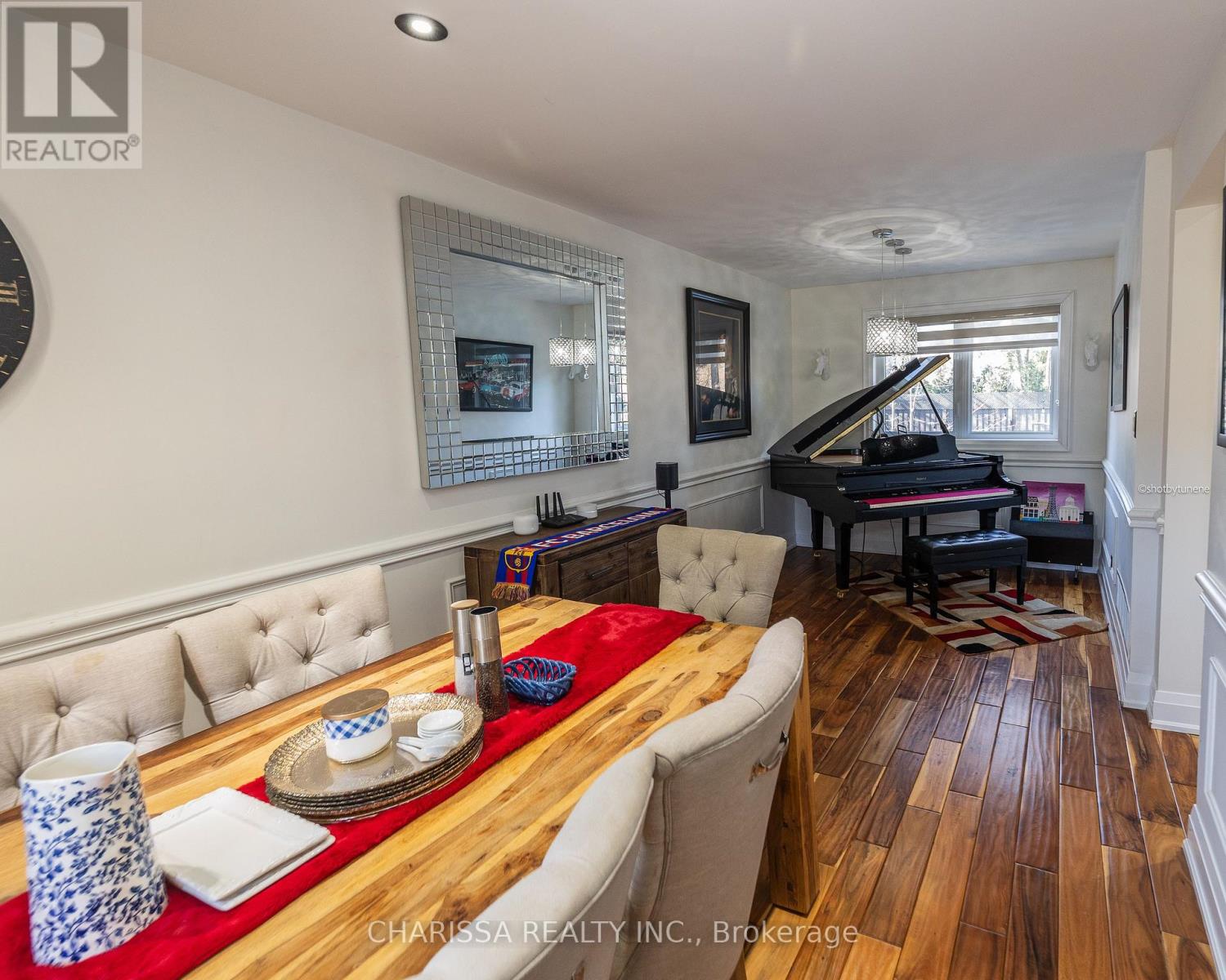 A dining room with a wooden table and chairs.