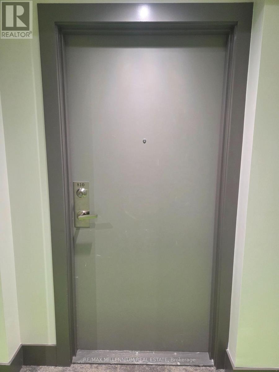 A door with a handle and a keypad on it.
