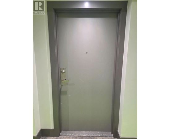 A door with a handle and a keypad on it.