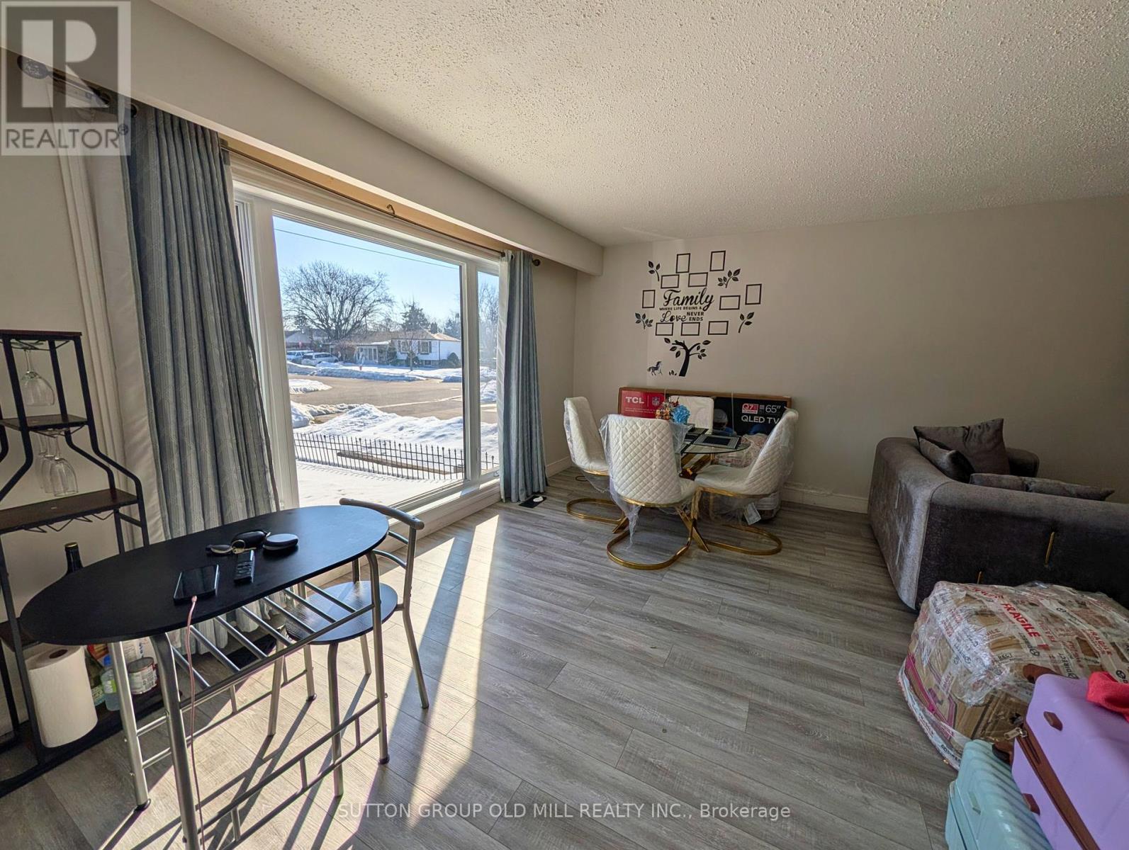 A sunny room with a table and chairs and a couch.