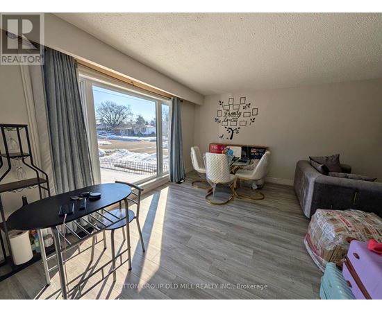 A sunny room with a table and chairs and a couch.