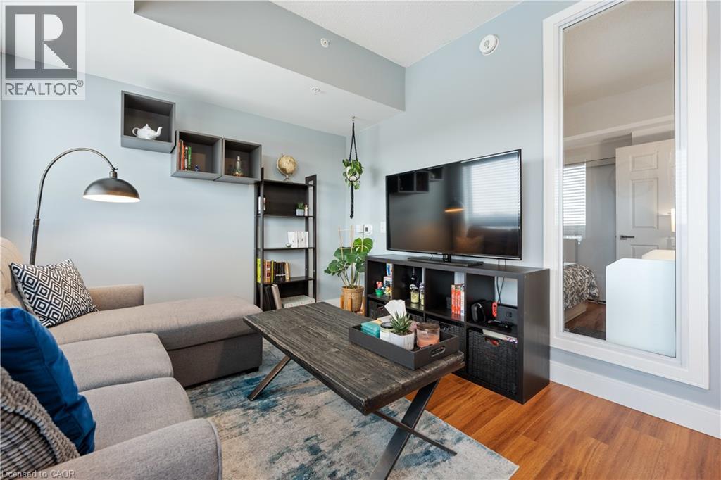 A living room with a grey couch and a wooden coffee table.