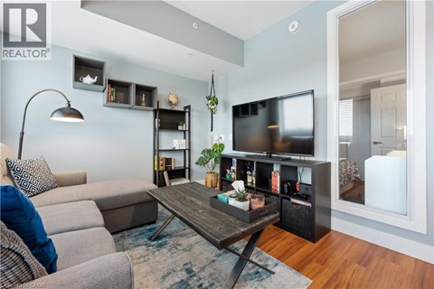 A living room with a grey couch and a wooden coffee table.