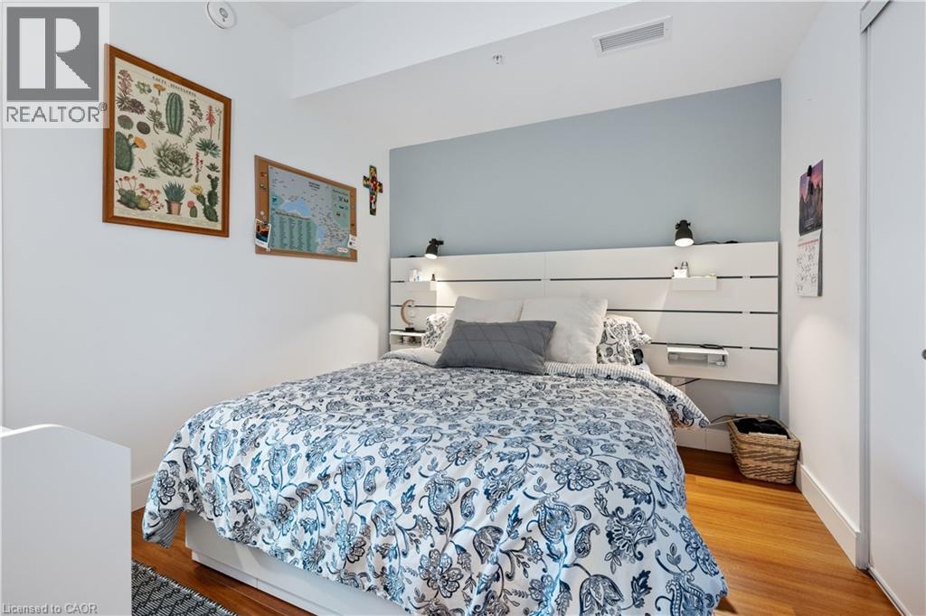 A bedroom with a bed and a painting on the wall.