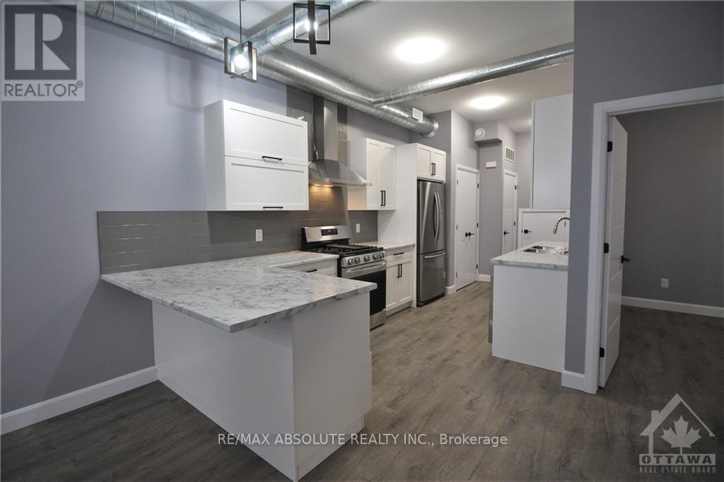 A kitchen area with a countertop and cabinets.