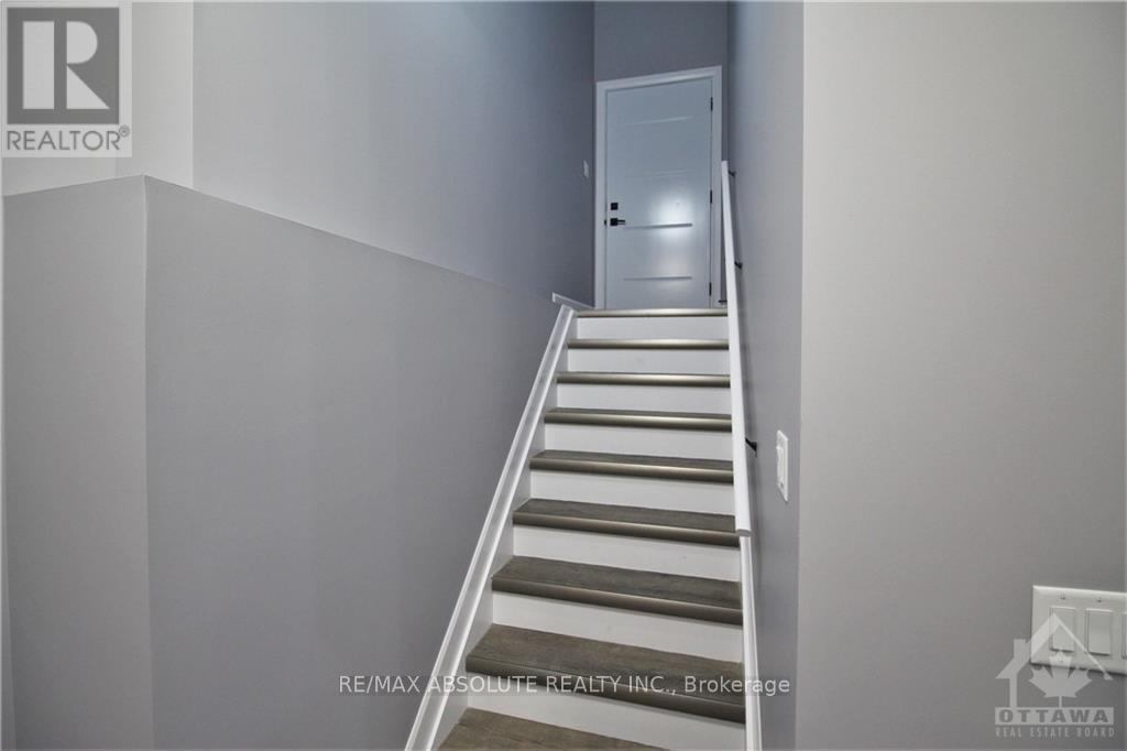 A staircase in a house with a white door at the top.