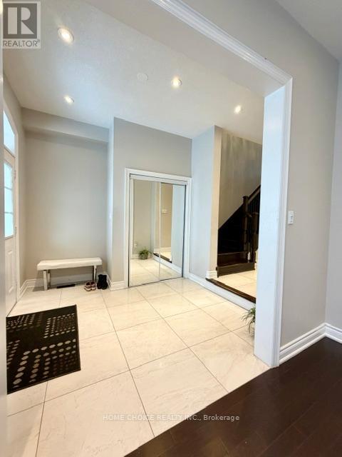 A spacious room with a bench and a staircase.